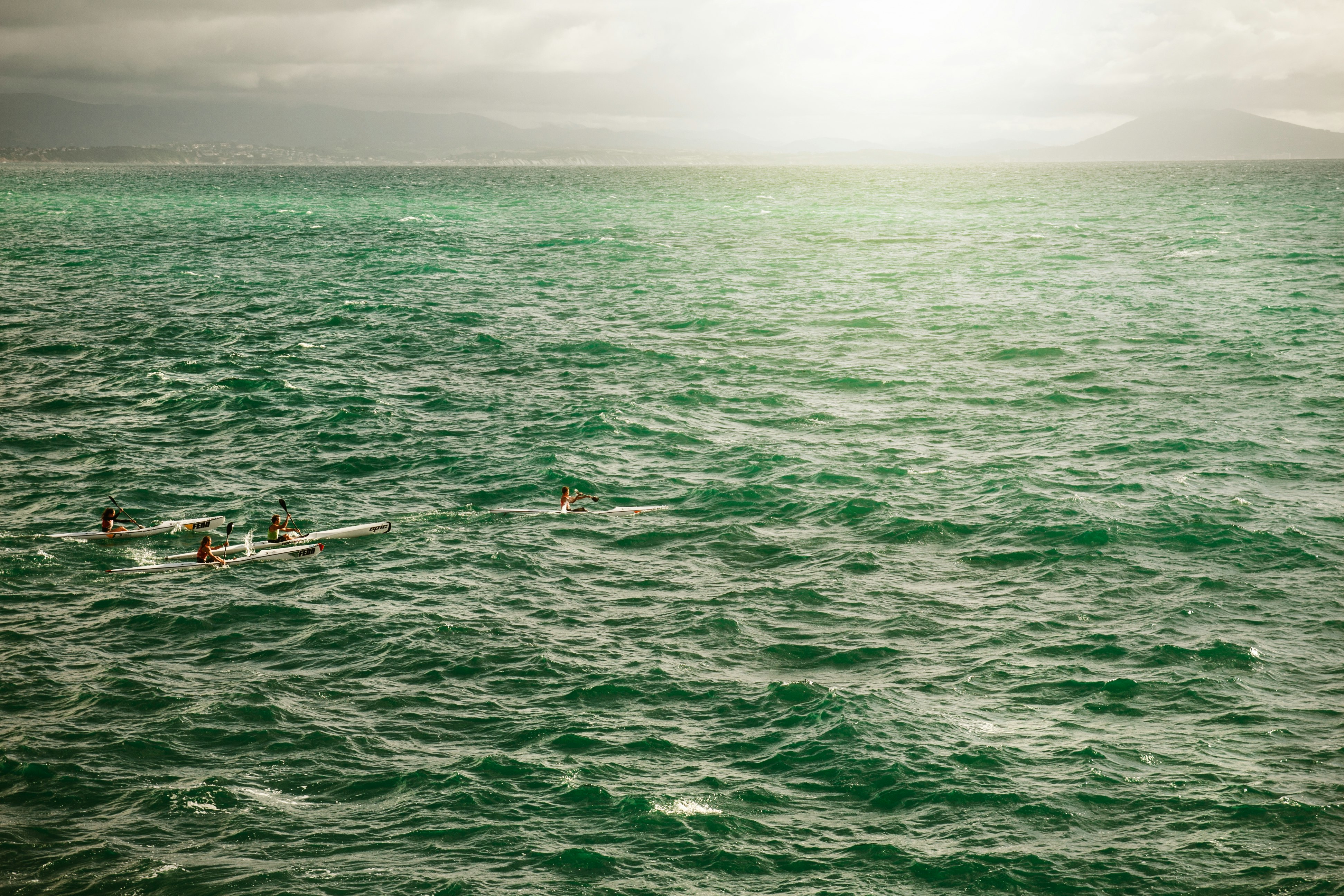 two person on boat on body of water